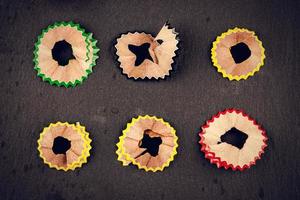 Color shavings pencils on black background viewed from above. Vintage style. Horizontal image. photo