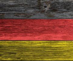 Weathered German flag colored wooden plank background. Texture with copy space. photo