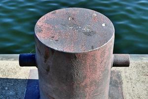 Different bollards and technical installations of vessel traffic at a port photo