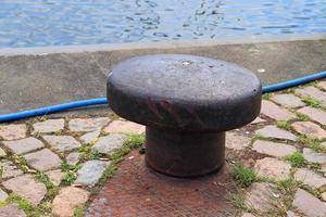 Different bollards and technical installations of vessel traffic at a port photo