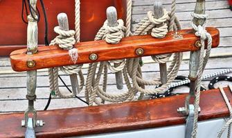 Detailed close up detail of ropes and cordage in the rigging of an old wooden vintage sailboat photo