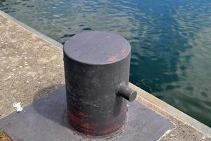 Different bollards and technical installations of vessel traffic at a port photo