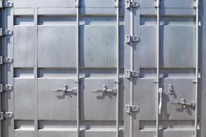 Detailed close up view on metal and steel surfaces on a silver cargo containter photo