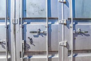 Detailed close up view on metal and steel surfaces on a silver cargo containter photo