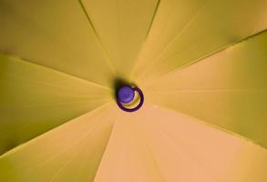 Close up view at the colorful surfaces of a rainproof umbrella photo