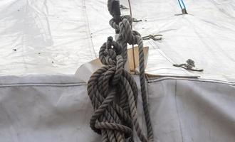 Detailed close up detail of ropes and cordage in the rigging of an old wooden vintage sailboat photo