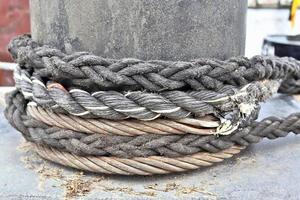 Detailed close up detail of ropes and cordage in the rigging of an old wooden vintage sailboat photo