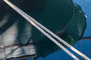 Detailed close up detail of ropes and cordage in the rigging of an old wooden vintage sailboat photo