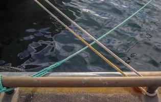 Detailed close up detail of ropes and cordage in the rigging of an old wooden vintage sailboat photo