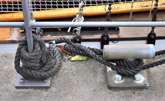 Detailed close up detail of ropes and cordage in the rigging of an old wooden vintage sailboat photo