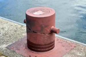 Different bollards and technical installations of vessel traffic at a port photo