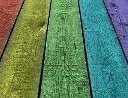 Weathered rainbow colored wooden plank background. Texture with copy space. photo