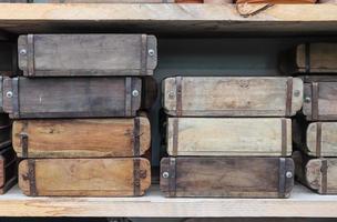 Vintage wooden crates in a shelf for sale in a small shop. photo