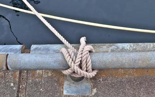 Detailed close up detail of ropes and cordage in the rigging of an old wooden vintage sailboat photo