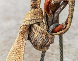 Detailed close up detail of ropes and cordage in the rigging of an old wooden vintage sailboat photo