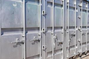 Detailed close up view on metal and steel surfaces on a silver cargo containter photo