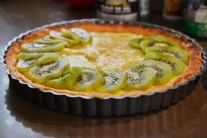 Kiwi pie, with kiwis laid out during cooking photo