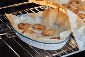 Dough circles are ready after baking in the oven for appetizer with ricotta cheese and cherry tomatoes photo