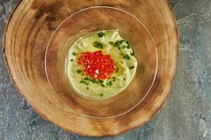 Avocado mousse with ginger and red caviar. Exquisite French food