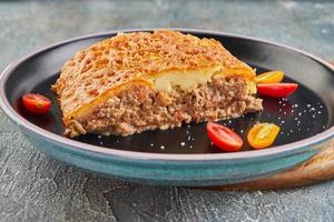 Pie with beef Tourtier and cherry tomatoes. Pie with minced meat photo