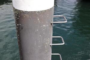 Different bollards and technical installations of vessel traffic at a port photo