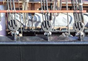 Detailed close up detail of ropes and cordage in the rigging of an old wooden vintage sailboat photo