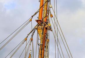 Detailed close up detail of ropes and cordage in the rigging of an old wooden vintage sailboat photo