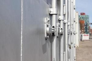 Detailed close up view on metal and steel surfaces on a silver cargo containter photo