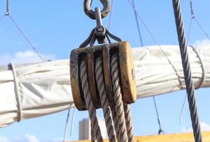 Detailed close up detail of ropes and cordage in the rigging of an old wooden vintage sailboat photo