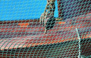 Close up on a blue fishing net at the harbour of Kiel in Germany photo