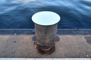 Different bollards and technical installations of vessel traffic at a port photo