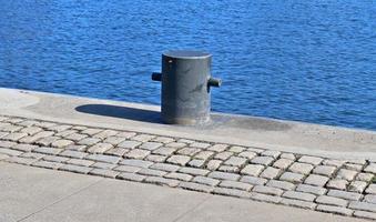 Different bollards and technical installations of vessel traffic at a port photo