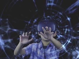 Boy wearing virtual reality glasses in modern interior design studio and trying to touch dots network and  something appear in VR with exciting.Flares effect, blurred background concept. photo