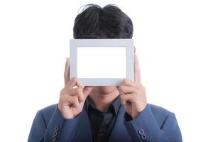 Asian businessman in a blue suit showed a blank photo frame in his hands.