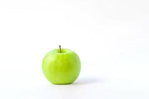 fresh green apple on clear solid and white background in studio light. photo