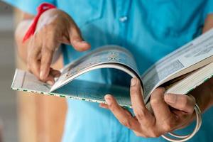 Art man is holding the Thai art book and finding the inspiration for his work. photo