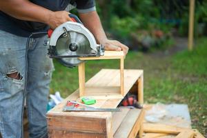 Asian carpenter are sawing the wood. photo