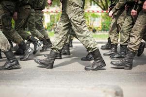 Marching soldiers in military boots photo