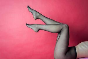 Legs of young caucasian woman in black tights photo