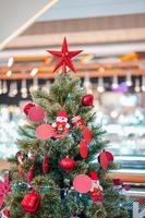 The big red star decoration topped of the Christmas's tree. photo