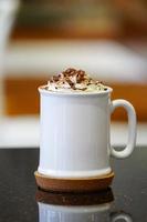 White Coffee cup and whip cream on top.