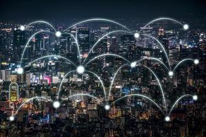 Business Network Connection laser beam and center accessing point on Aerial cityscape view high building at the night. Clipping path. photo