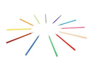 round radius and circle arrangement by blunt colour pencils directed and pointed to the center of the wheel. It has copy space on the white background for any text insertion. photo