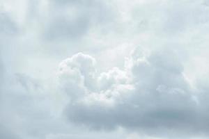 Close up telephoto to calm white fluffy cotton clouds flows in the sky. photo