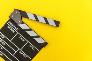 Filmmaker profession. Classic director empty film making clapperboard or movie slate isolated on yellow background. Video production film cinema industry concept. Flat lay top view copy space mock up. photo