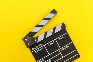 Filmmaker profession. Classic director empty film making clapperboard or movie slate isolated on yellow background. Video production film cinema industry concept. Flat lay top view copy space mock up. photo