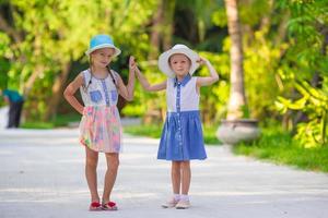 Adorable little girls during summer tropical vacation photo
