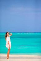 Young beautiful woman during tropical beach vacation photo