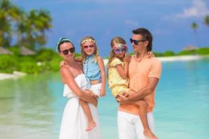 Young family of four on beach vacation photo