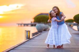 Adorable little girls during summer vacation in the evening photo